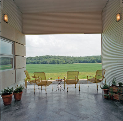 A breezeway connecting the garage and the house is a fine place to sit and enjoy the southern view of the cropland.
